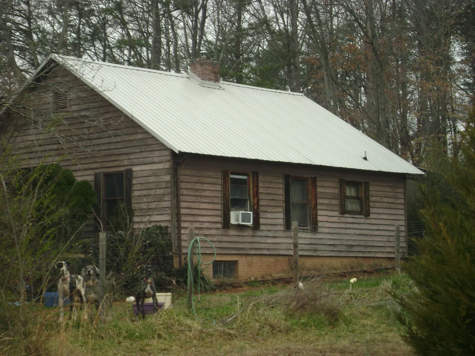 White metal roof on an old wood sided farmhouse, from a Metal Roof Installation job in Darby